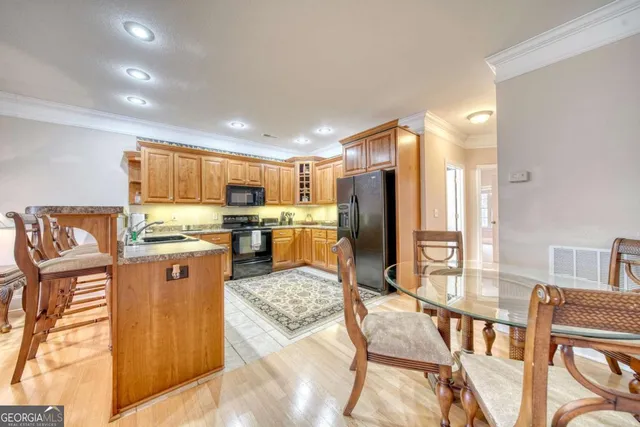a kitchen with stainless steel appliances granite countertop sink refrigerator and microwave