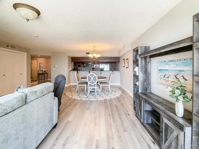 a view of a dining room with furniture and chandelier