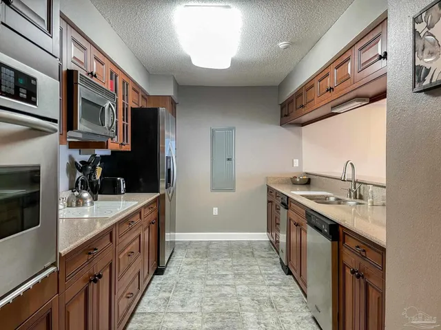 a kitchen with stainless steel appliances granite countertop a sink and cabinets