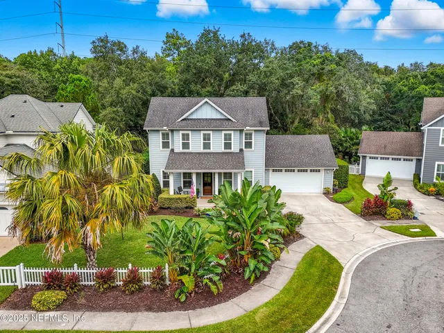 an aerial view of a house with a yard basket ball court and outdoor seating