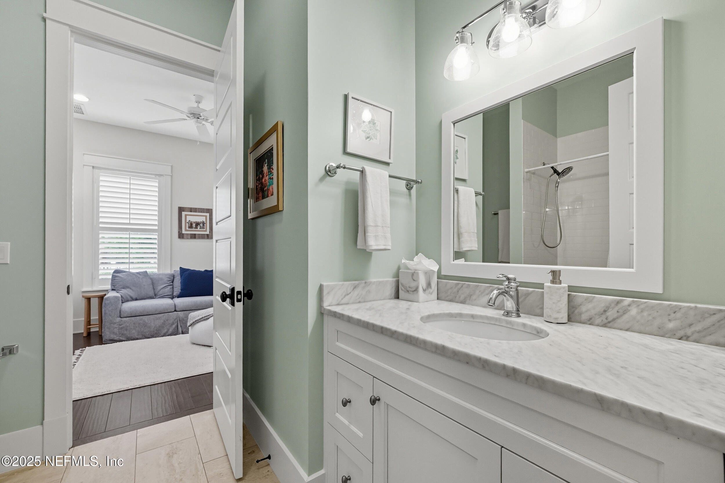 951 Paradise Circle Atlantic Beach, FL 32233 - Photo 12 of 76 a en suite bathroom with double vanity and a mirror