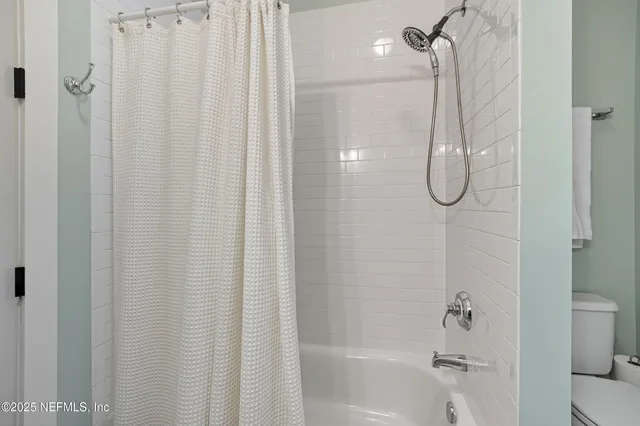a kitchen with stainless steel appliances a dining table chairs sink and cabinets