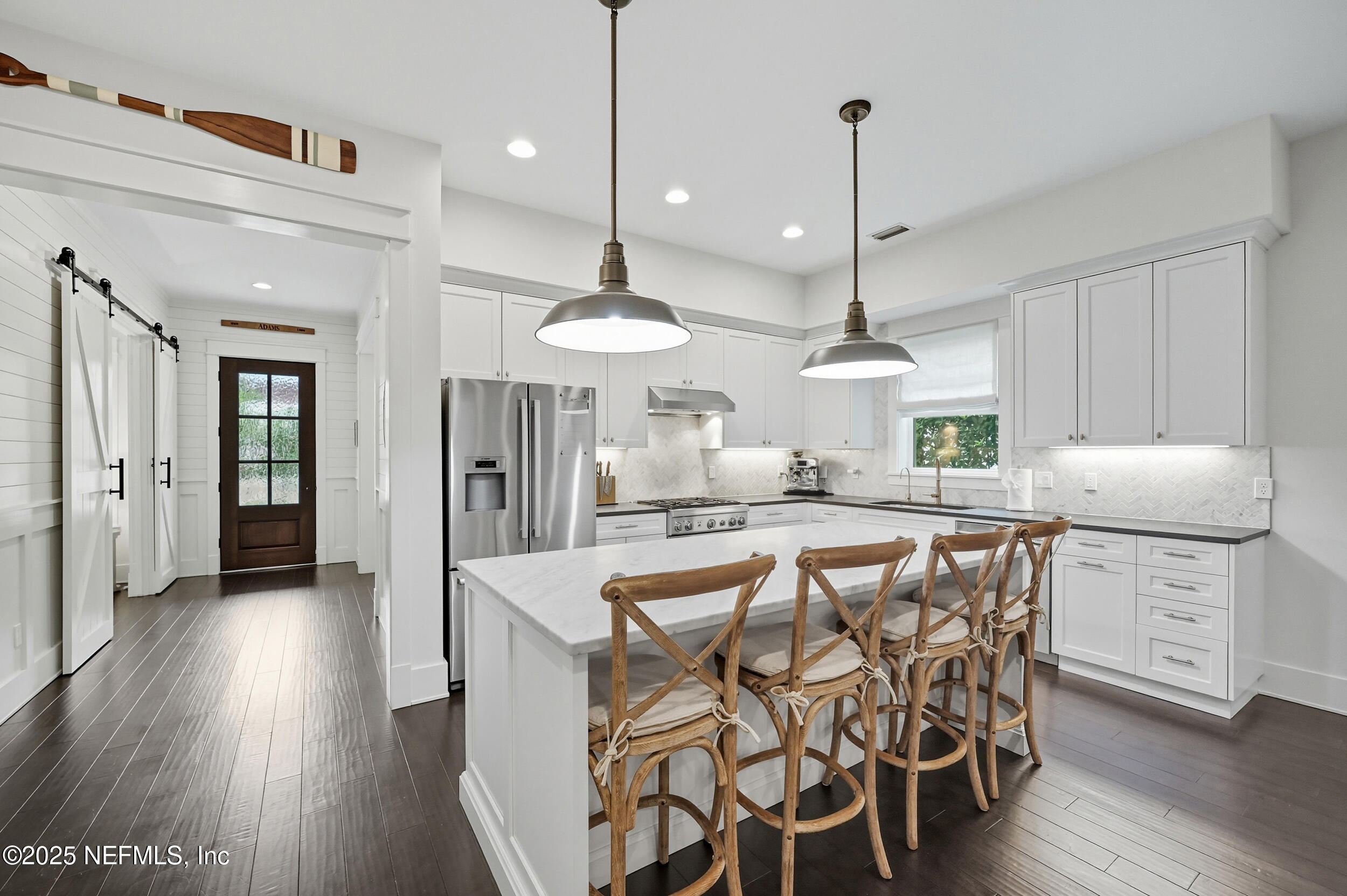 951 Paradise Circle Atlantic Beach, FL 32233 - Photo 14 of 76 a kitchen with stainless steel appliances kitchen island granite countertop a stove a refrigerator and wooden floor