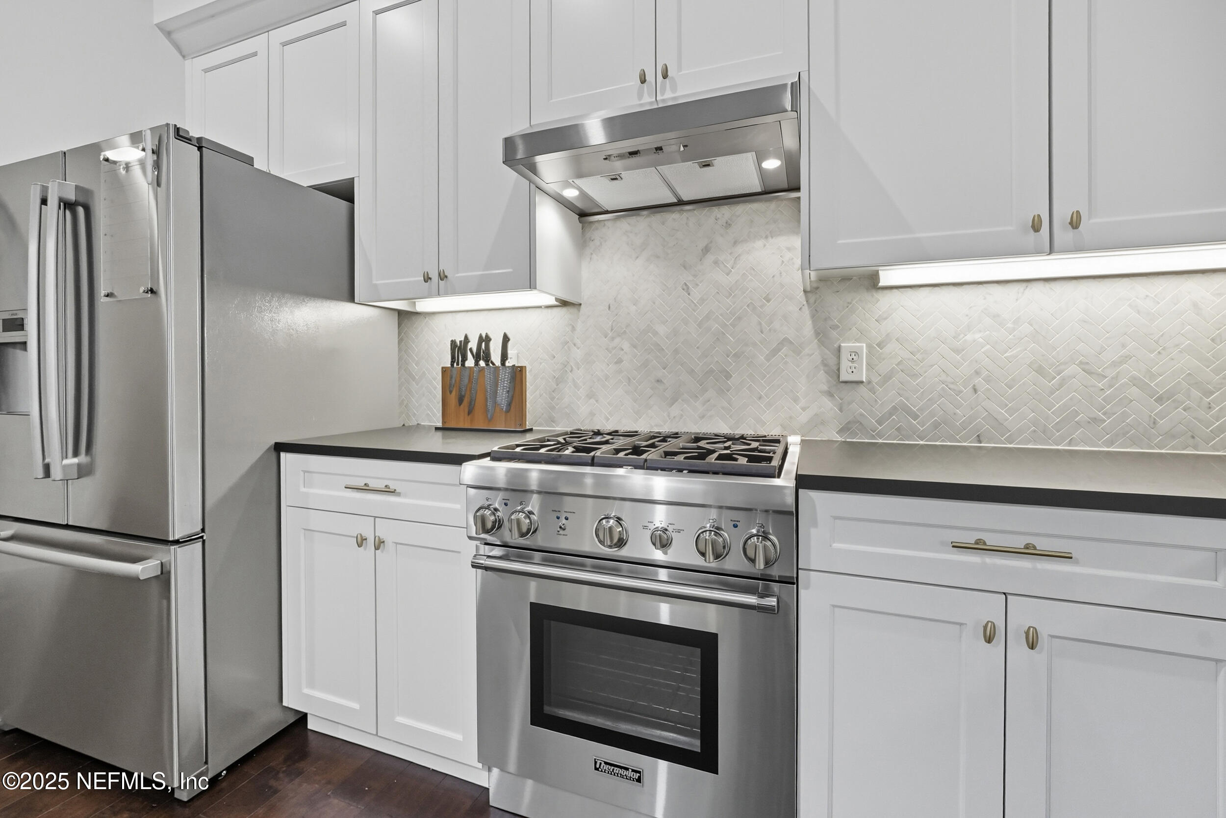 951 Paradise Circle Atlantic Beach, FL 32233 - Photo 16 of 76 a kitchen with stainless steel appliances white cabinets and a stove