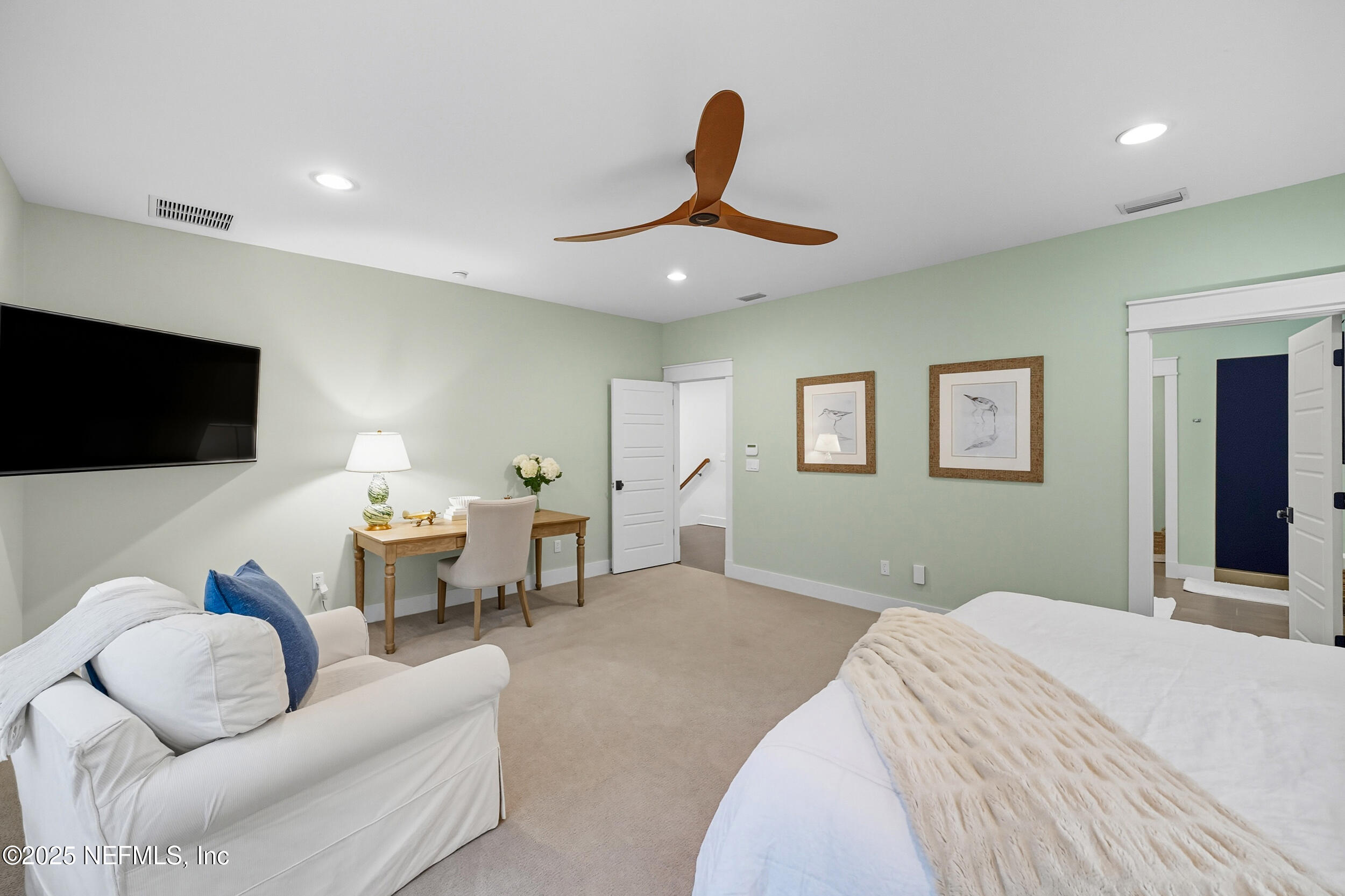 951 Paradise Circle Atlantic Beach, FL 32233 - Photo 25 of 76 a bedroom with a bed and a flat screen tv