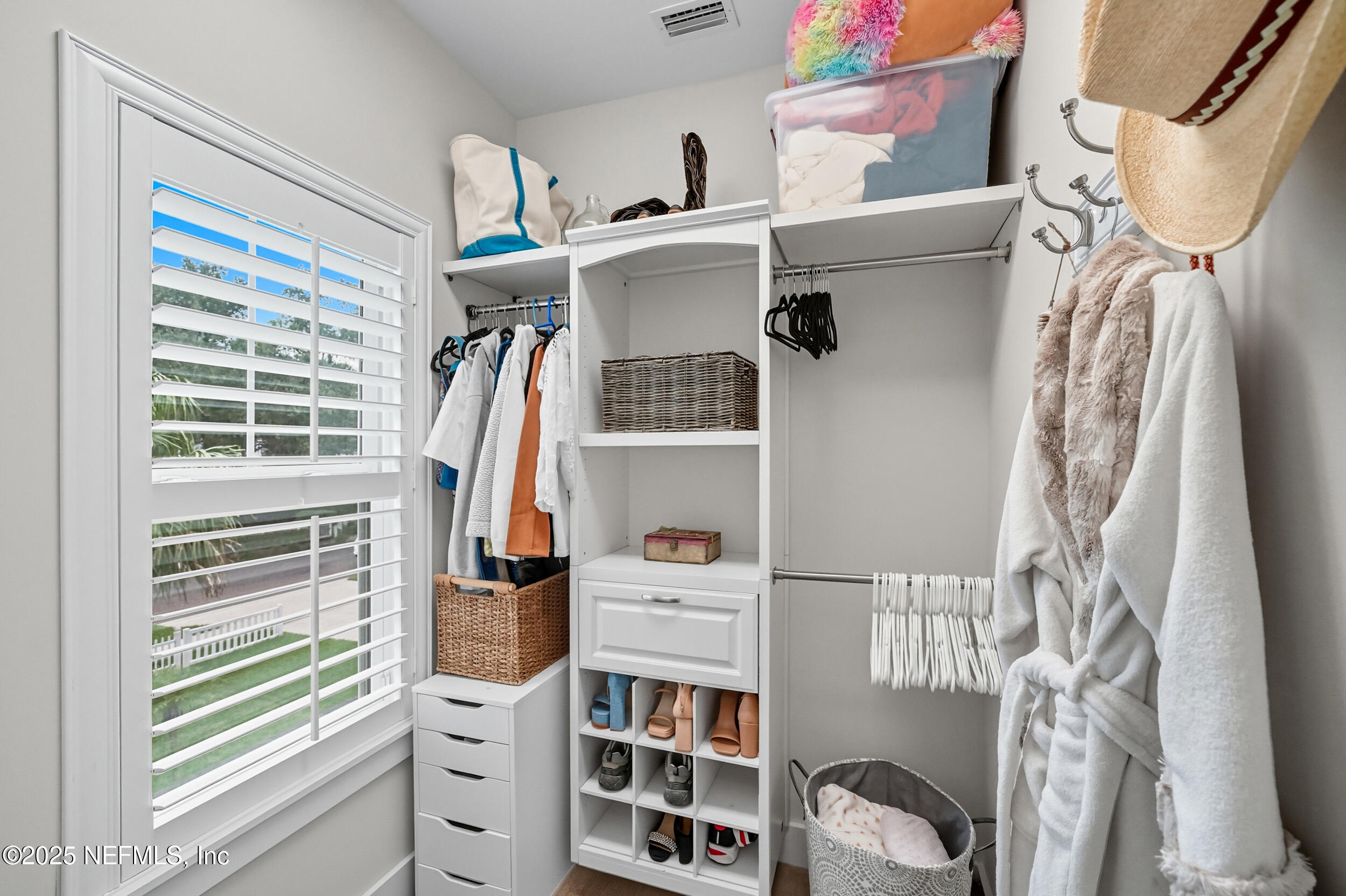 951 Paradise Circle Atlantic Beach, FL 32233 - Photo 29 of 76 a view of walk in closet with clothes and shoes