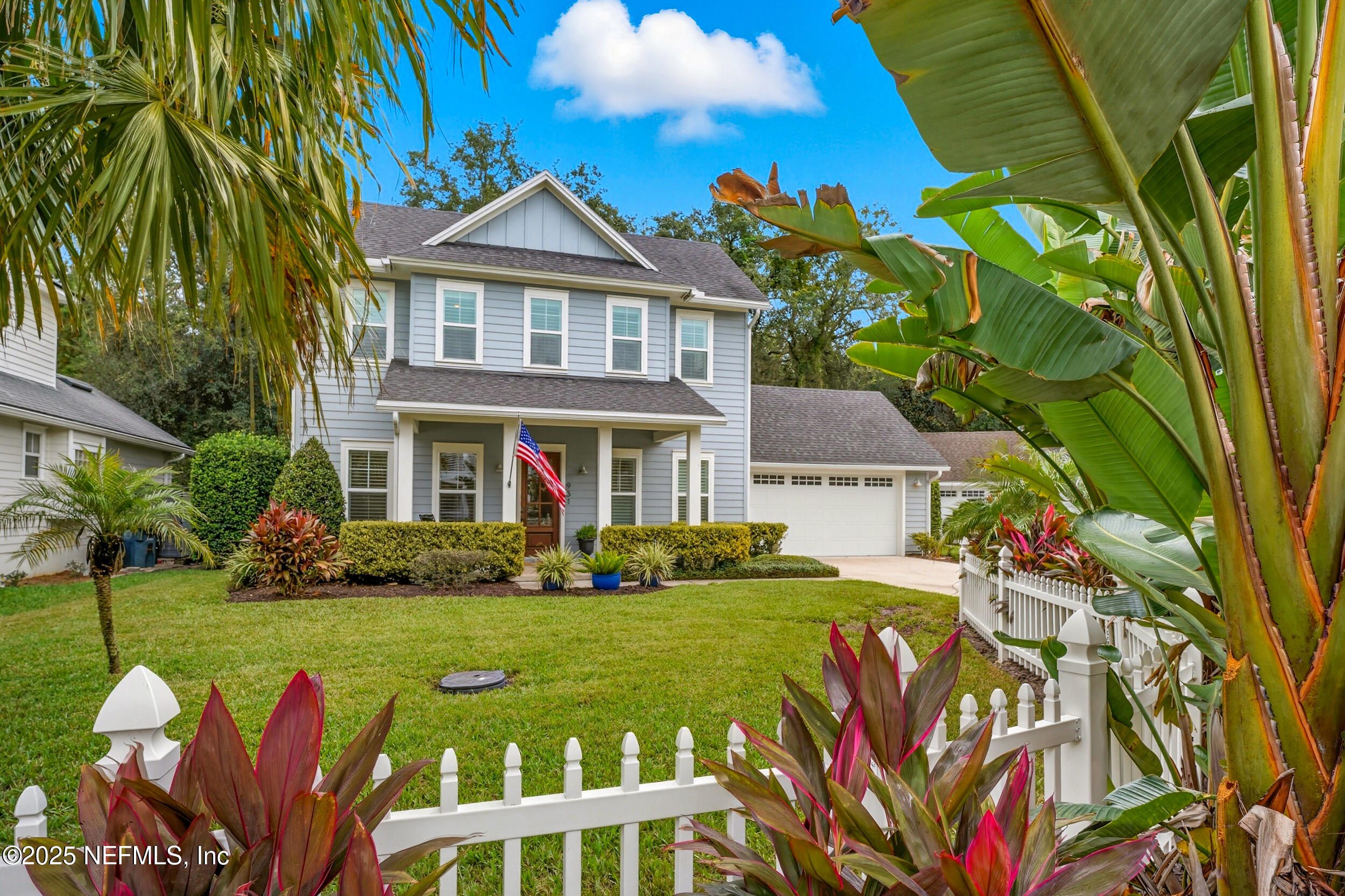 951 Paradise Circle Atlantic Beach, FL 32233 - Photo 3 of 76 a front view of a house with a yard table and chairs