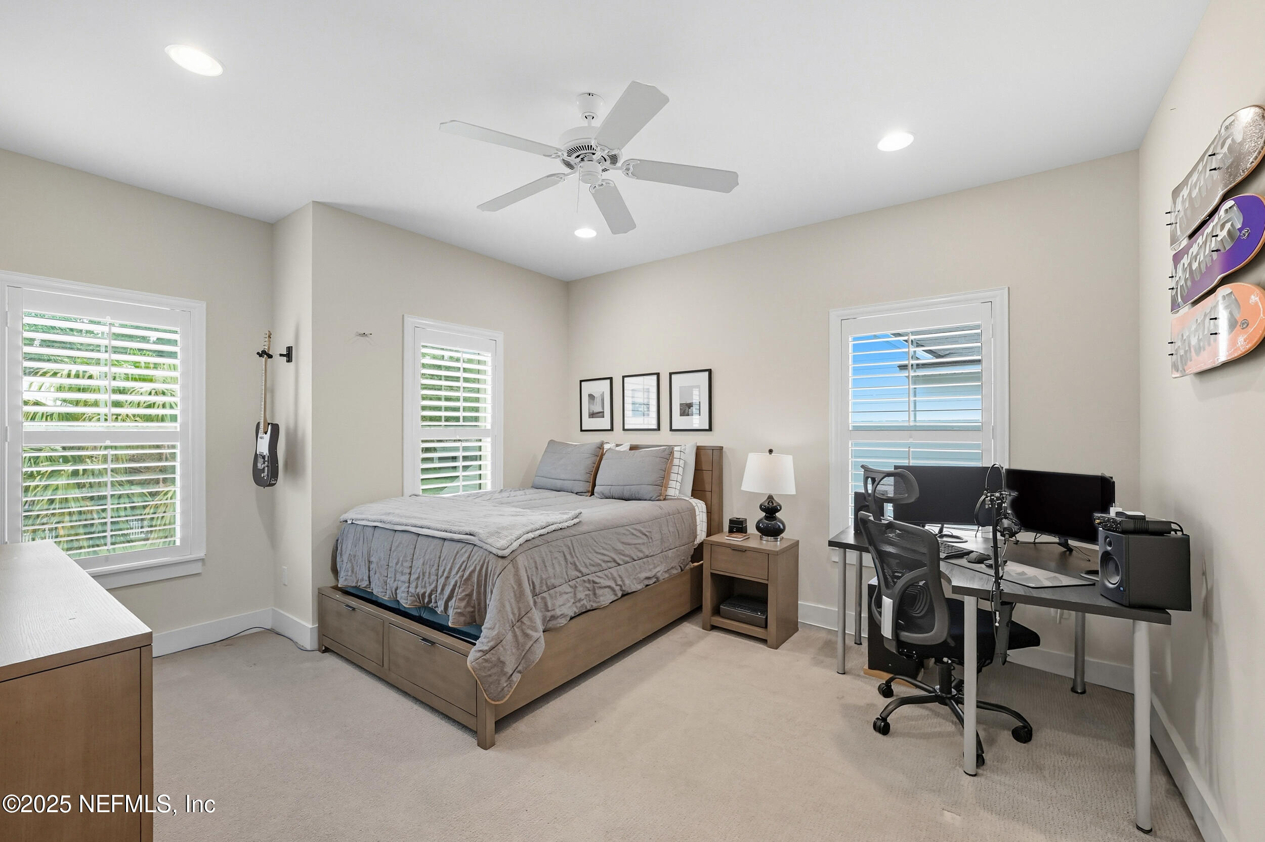 951 Paradise Circle Atlantic Beach, FL 32233 - Photo 32 of 76 a bedroom with a bed a desk and chair