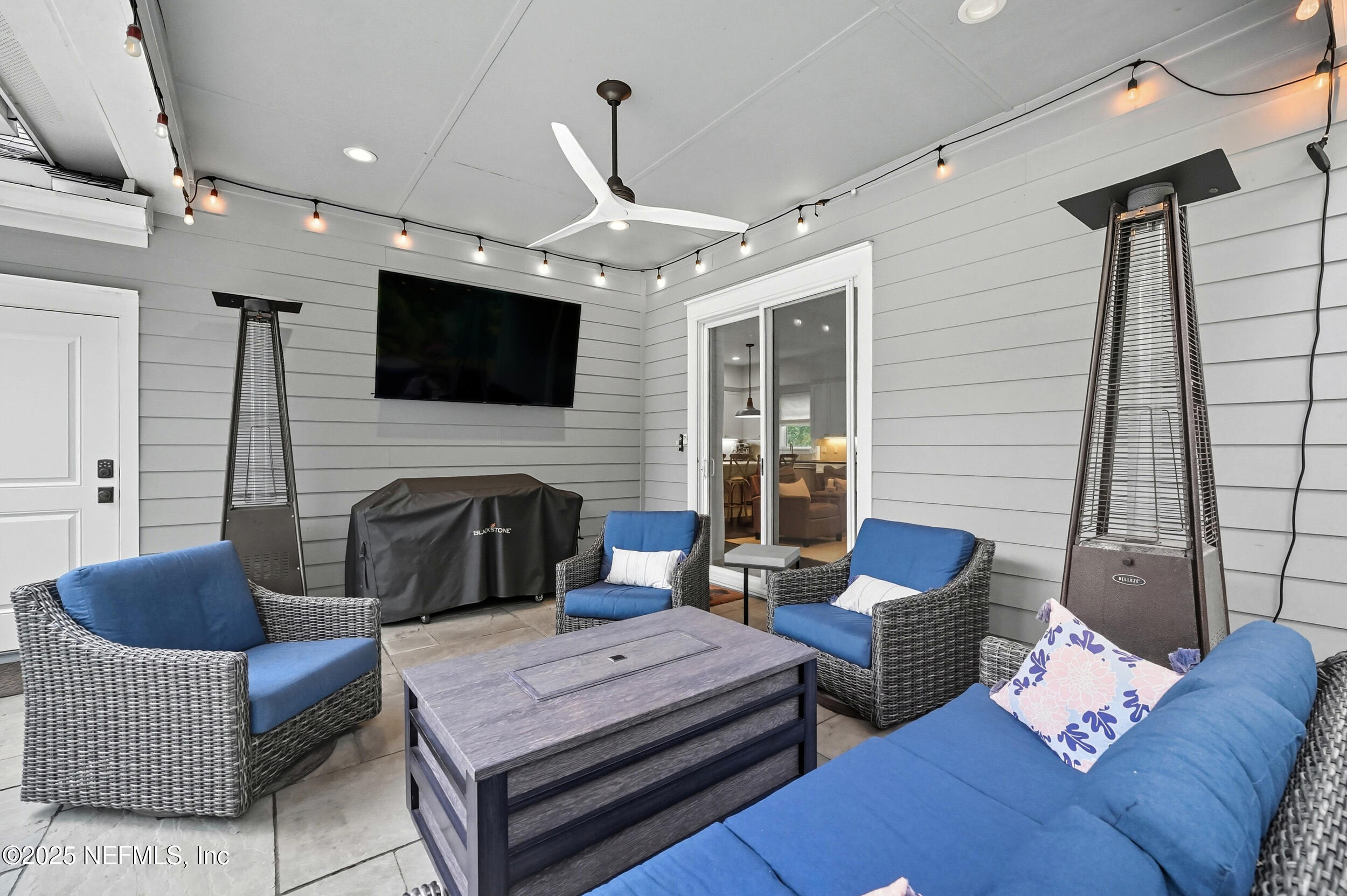 951 Paradise Circle Atlantic Beach, FL 32233 - Photo 35 of 76 a living room with furniture a fireplace and a flat screen tv