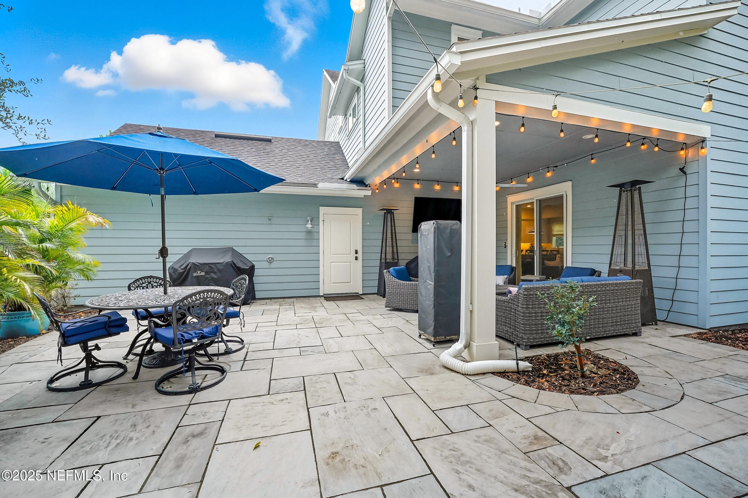 951 Paradise Circle Atlantic Beach, FL 32233 - Photo 39 of 76 a view of a patio with table and chairs under an umbrella
