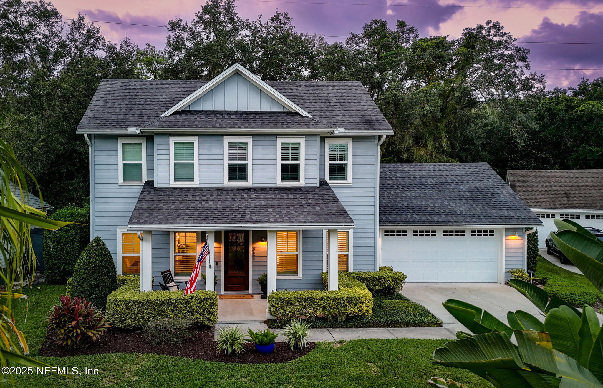 951 Paradise Circle Atlantic Beach, FL 32233 - Photo 74 of 76 a front view of a house with a yard and potted plants