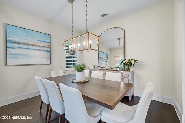 a kitchen with stainless steel appliances kitchen island granite countertop a stove a refrigerator and wooden floor