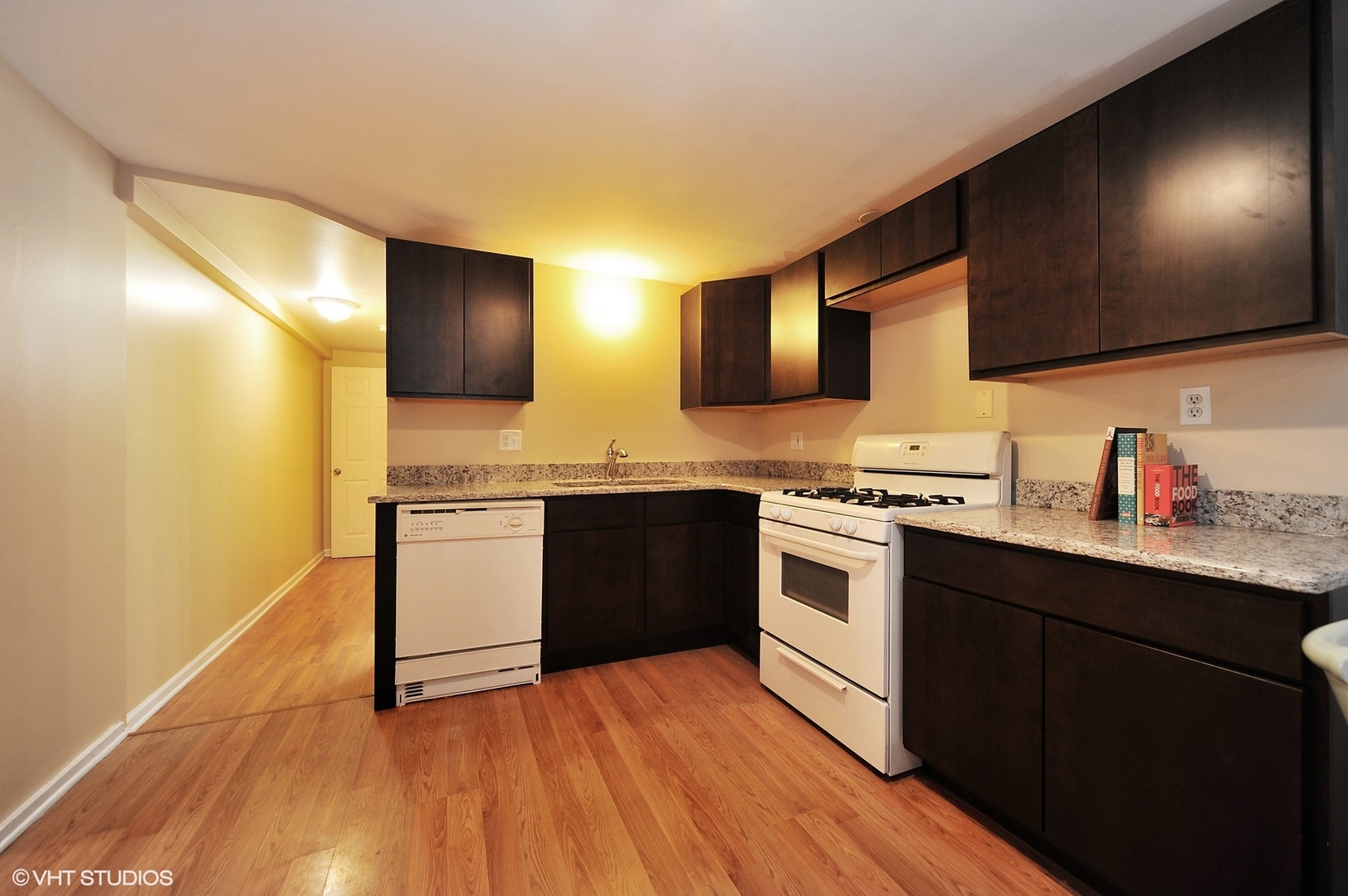 2710 West Fletcher Street Chicago, IL 60618 - Photo 18 of 24 a kitchen with stainless steel appliances kitchen island granite countertop a stove a sink and a microwave