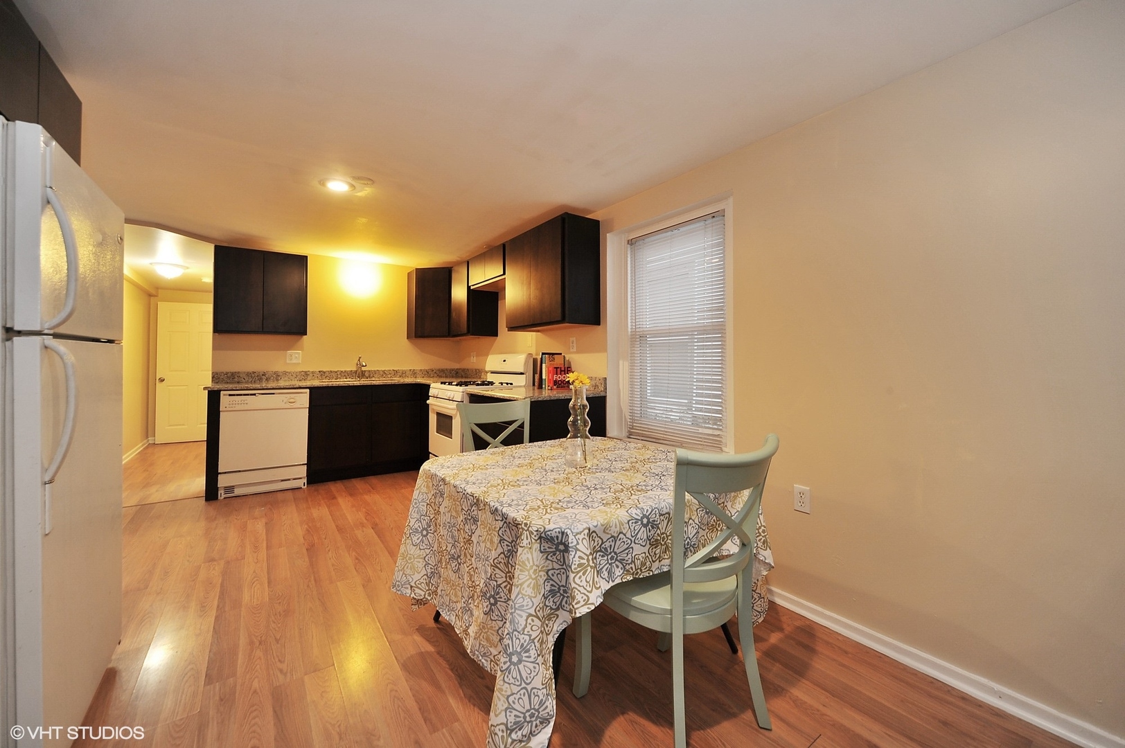 2710 West Fletcher Street Chicago, IL 60618 - Photo 20 of 24 a kitchen with cabinets and wooden floor