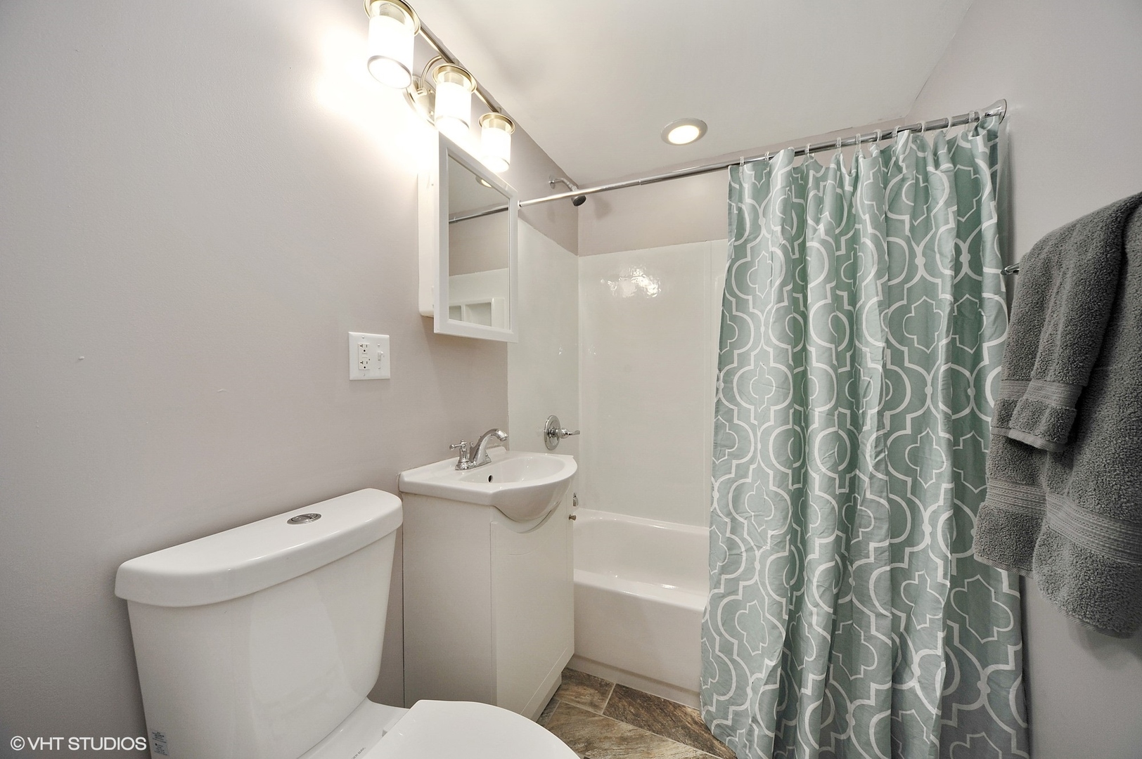 2710 West Fletcher Street Chicago, IL 60618 - Photo 23 of 24 a white toilet sitting next to a bathroom sink