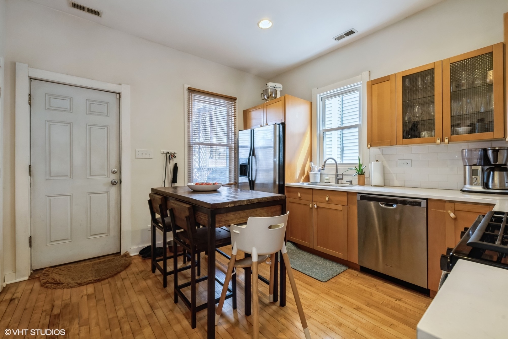 2710 West Fletcher Street Chicago, IL 60618 - Photo 4 of 24 a kitchen with stainless steel appliances granite countertop a table chairs sink and cabinets