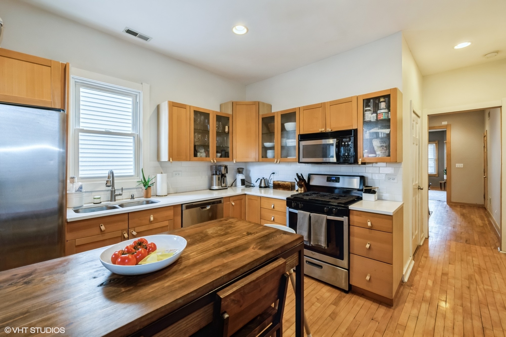 2710 West Fletcher Street Chicago, IL 60618 - Photo 5 of 24 a kitchen with a stove a sink and a microwave