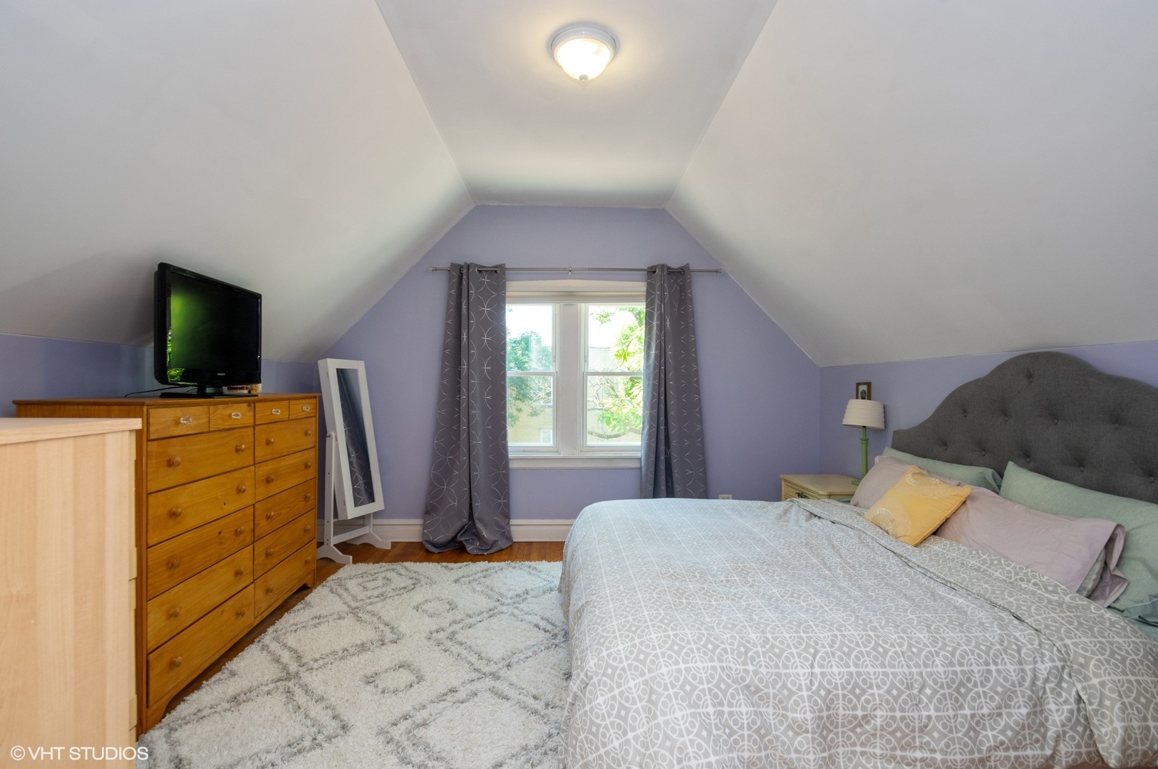 2710 West Fletcher Street Chicago, IL 60618 - Photo 10 of 24 a bedroom with a bed and flat tv screen on the dresser