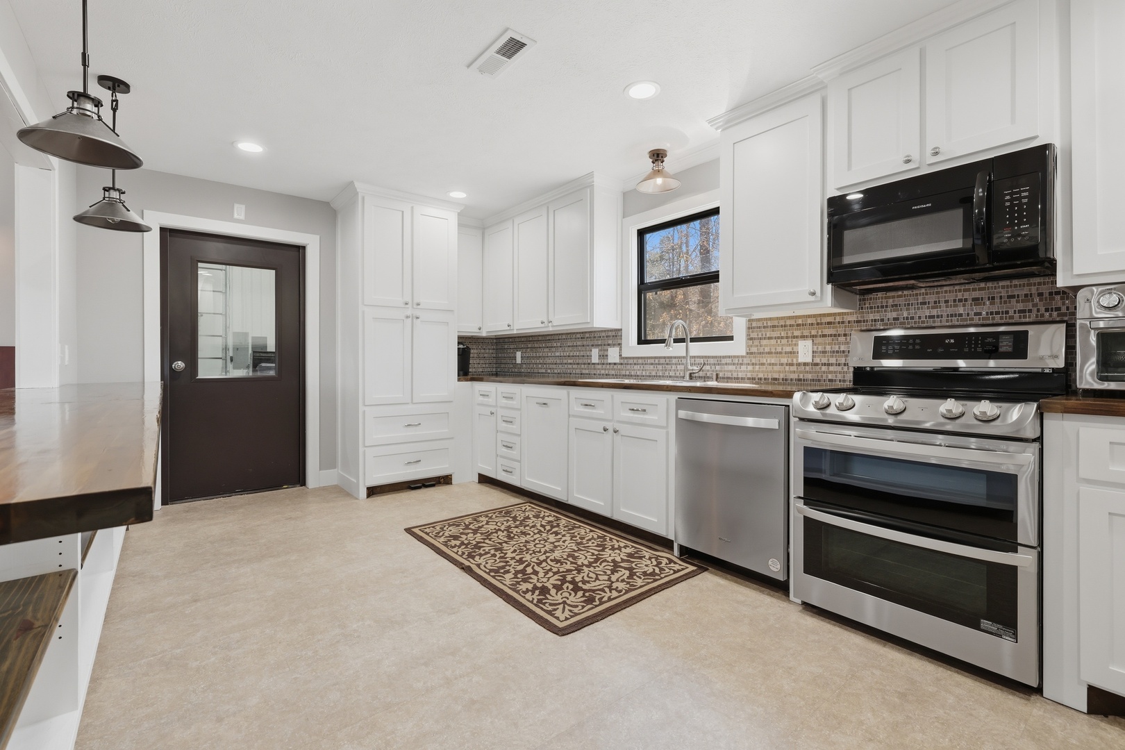 3675 Parrish Ridge Lane Goreville, IL 62939 - Photo 23 of 43 a kitchen with stainless steel appliances a stove a sink and a microwave