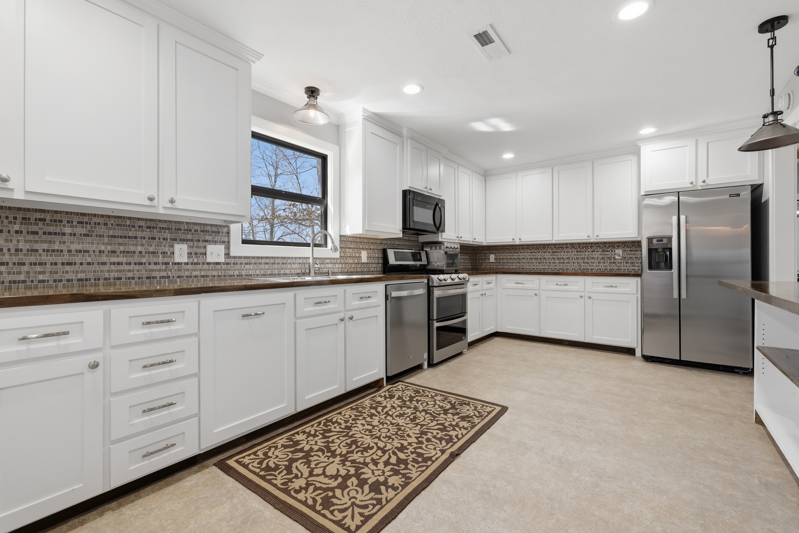 3675 Parrish Ridge Lane Goreville, IL 62939 - Photo 24 of 43 a kitchen with granite countertop a sink stainless steel appliances and cabinets