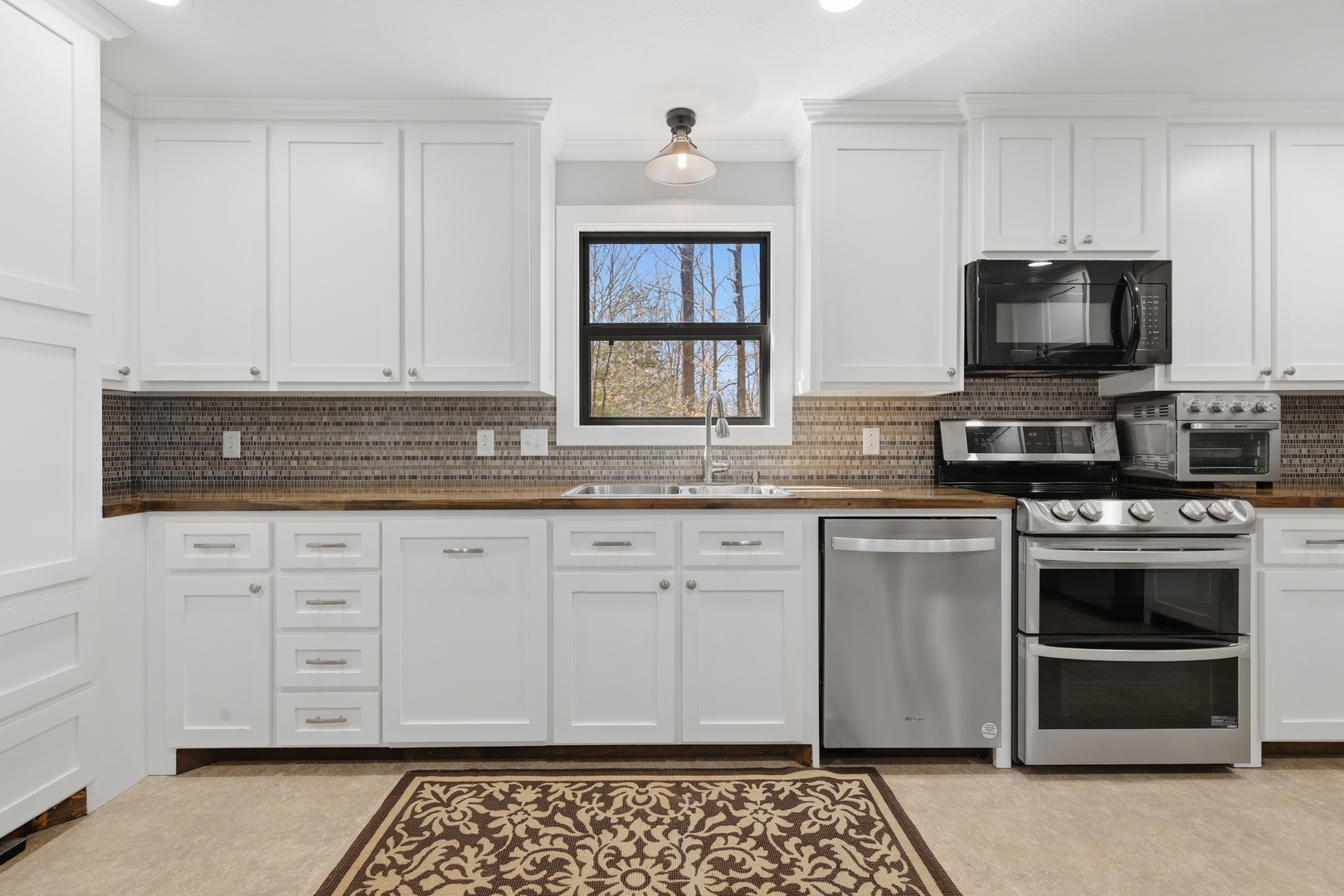 3675 Parrish Ridge Lane Goreville, IL 62939 - Photo 28 of 43 a kitchen with granite countertop a stove sink and microwave