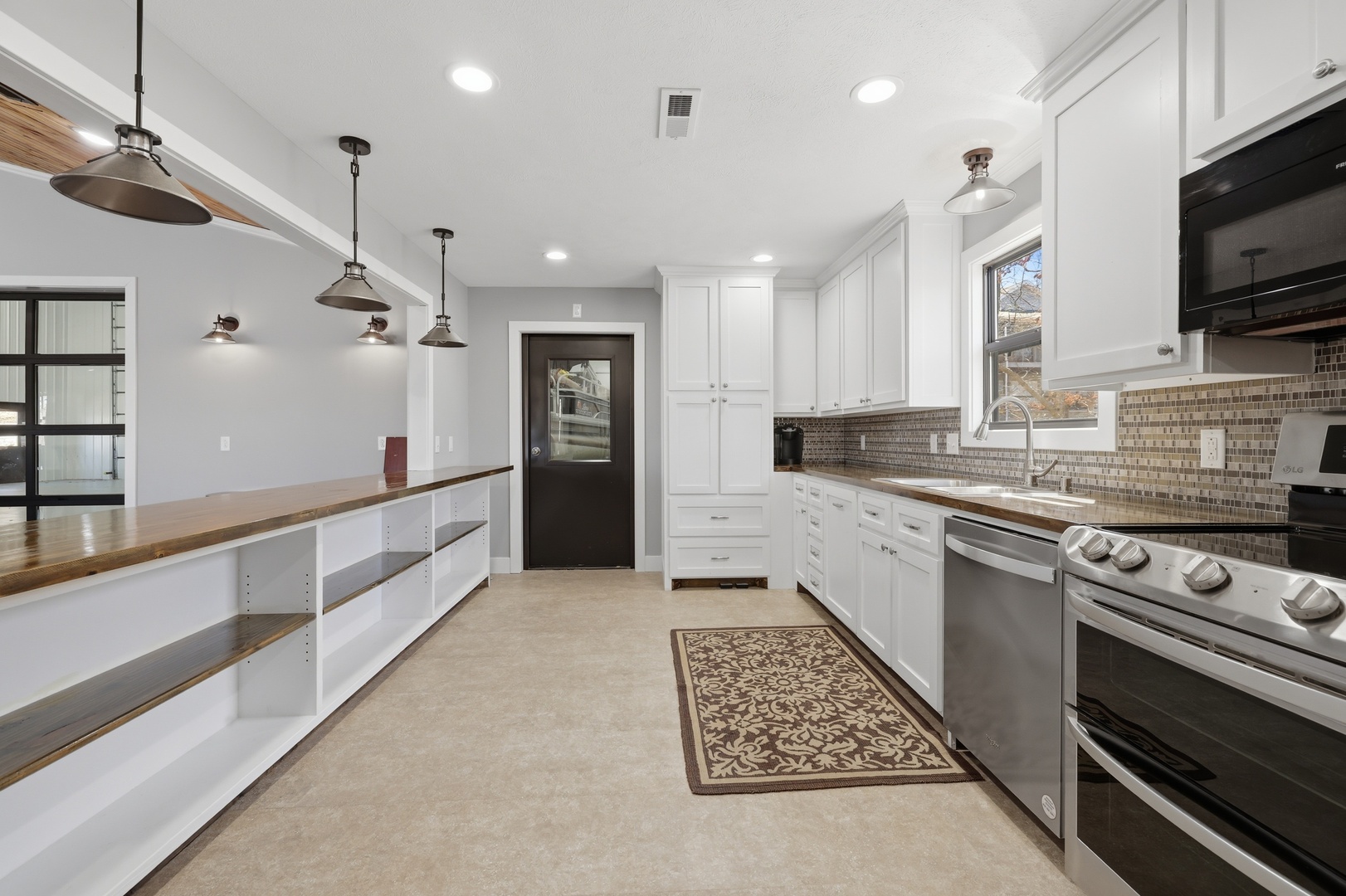 3675 Parrish Ridge Lane Goreville, IL 62939 - Photo 29 of 43 a large kitchen with stainless steel appliances granite countertop a stove a sink and a refrigerator