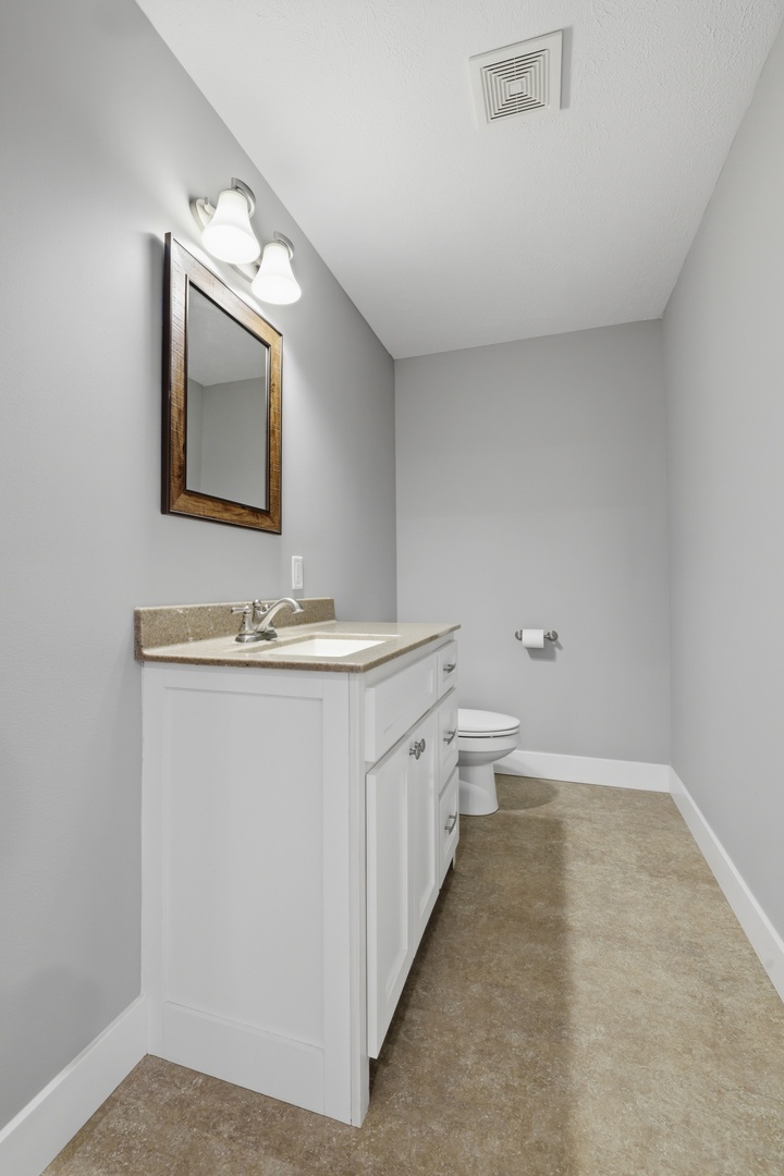 3675 Parrish Ridge Lane Goreville, IL 62939 - Photo 30 of 43 a bathroom with a toilet sink and mirror