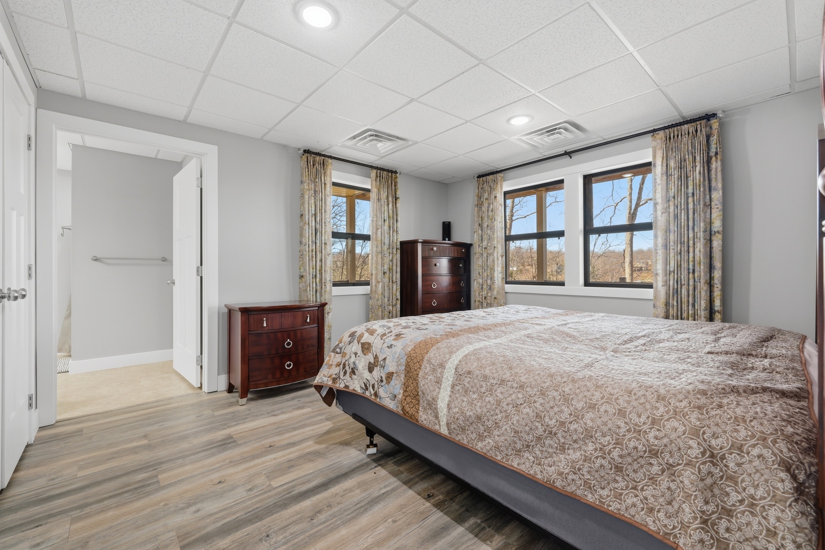 3675 Parrish Ridge Lane Goreville, IL 62939 - Photo 39 of 43 a bedroom with a large bed and wooden floor