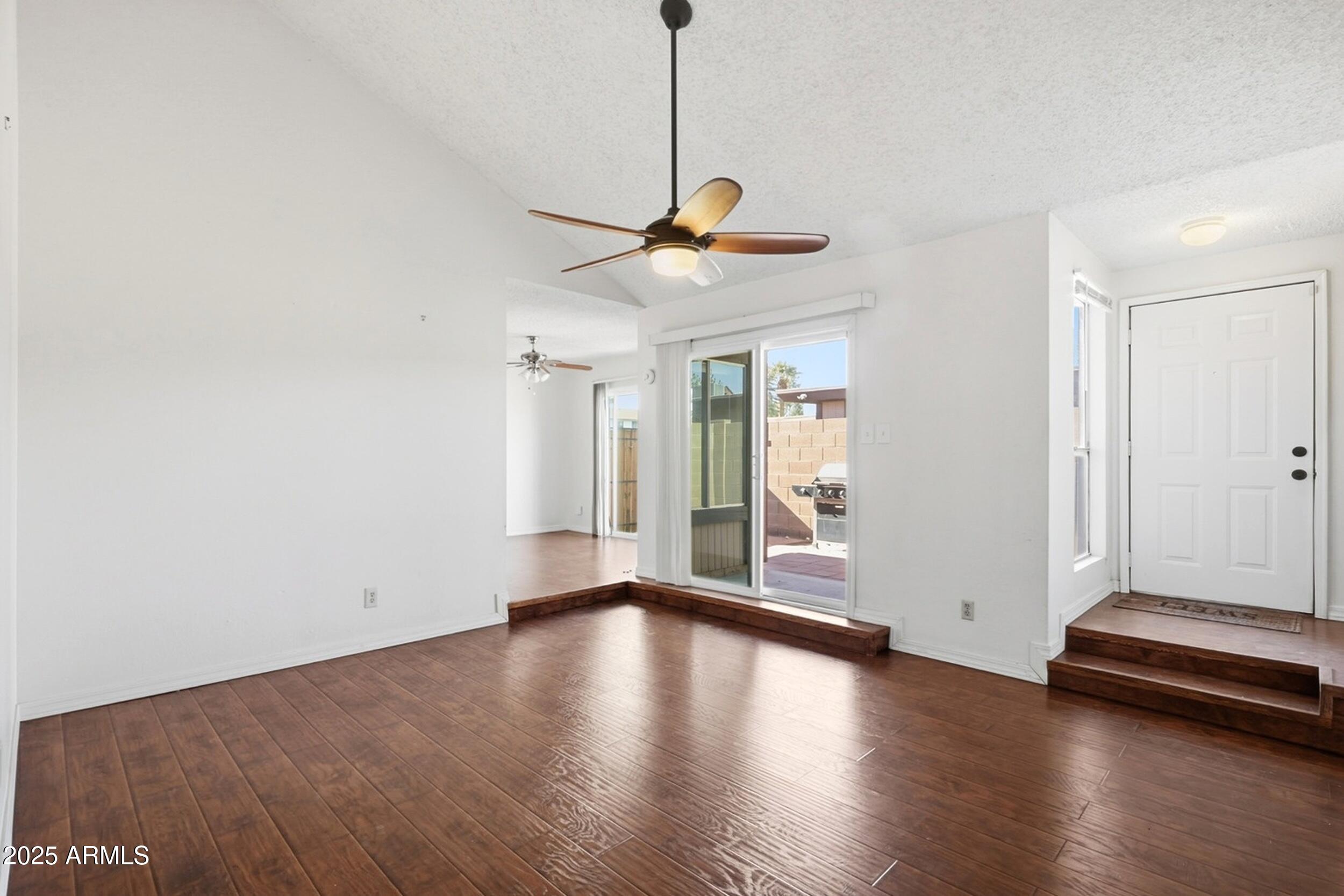 1831 East Kirkland Lane, Unit B Tempe, AZ 85288 - Photo 1 of 33 a view of a livingroom with wooden floor and a ceiling fan