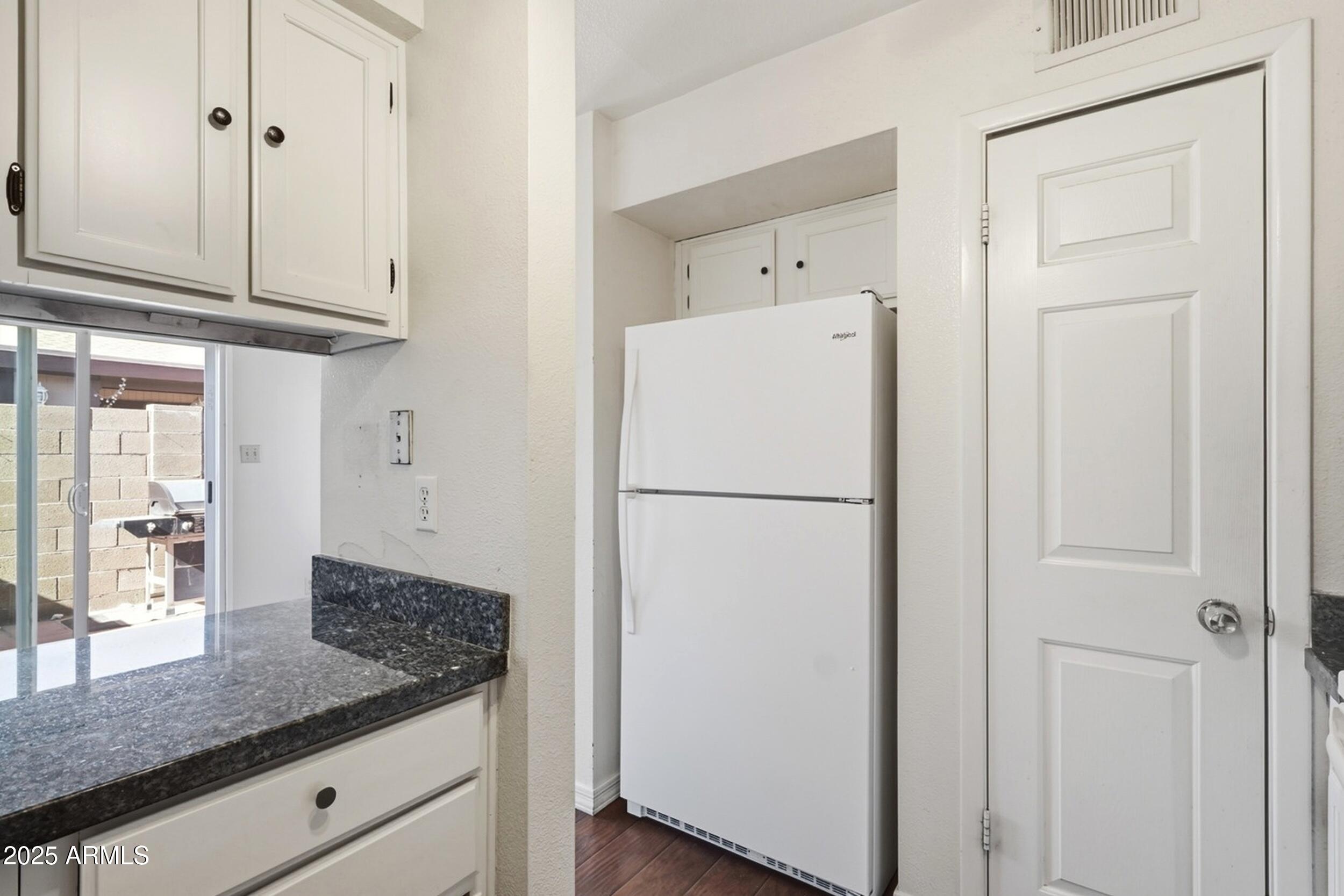 1831 East Kirkland Lane, Unit B Tempe, AZ 85288 - Photo 11 of 33 a white refrigerator freezer sitting inside of a kitchen