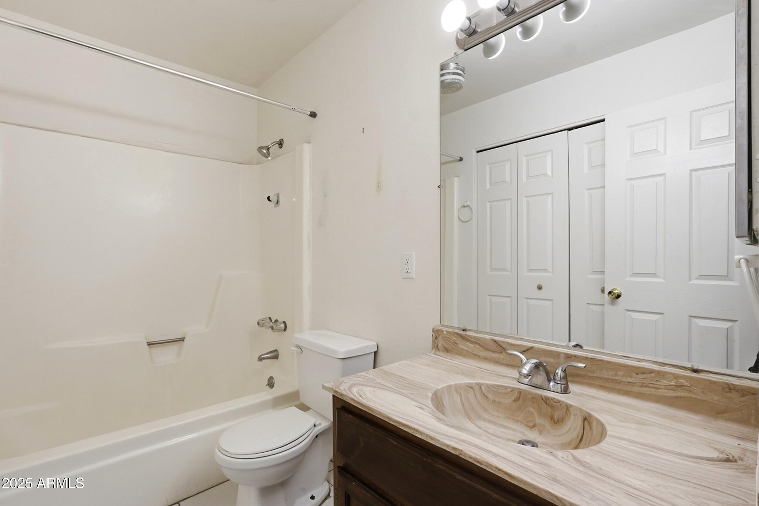 1831 East Kirkland Lane, Unit B Tempe, AZ 85288 - Photo 18 of 33 a bathroom with a granite countertop sink a toilet and shower