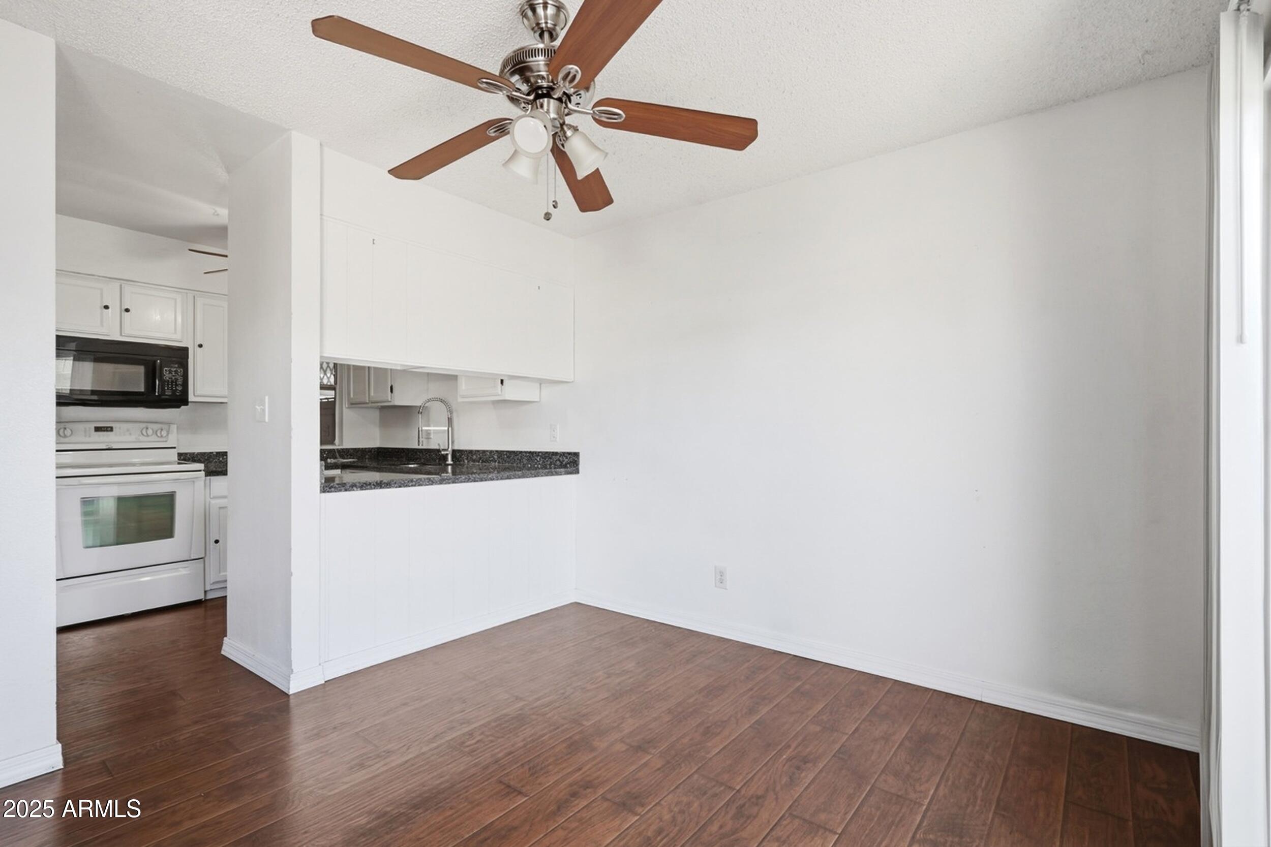 1831 East Kirkland Lane, Unit B Tempe, AZ 85288 - Photo 3 of 33 a view of a kitchen with microwave and stove top oven