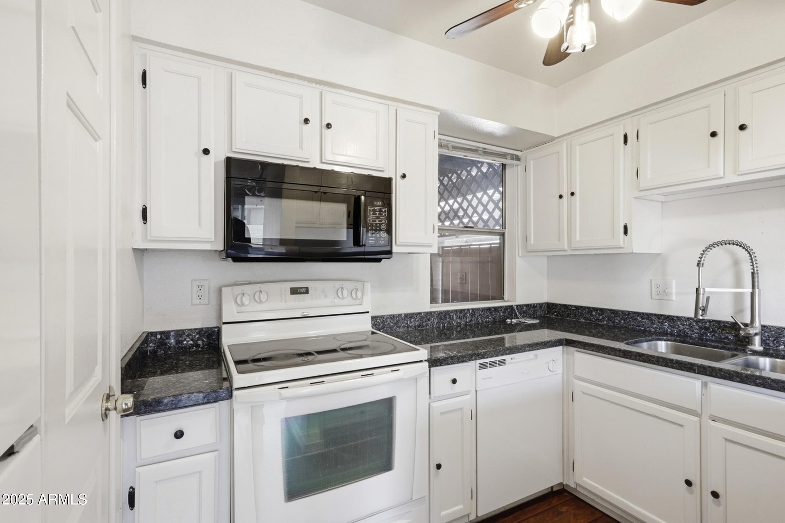 1831 East Kirkland Lane, Unit B Tempe, AZ 85288 - Photo 4 of 33 a kitchen with white cabinets and appliances