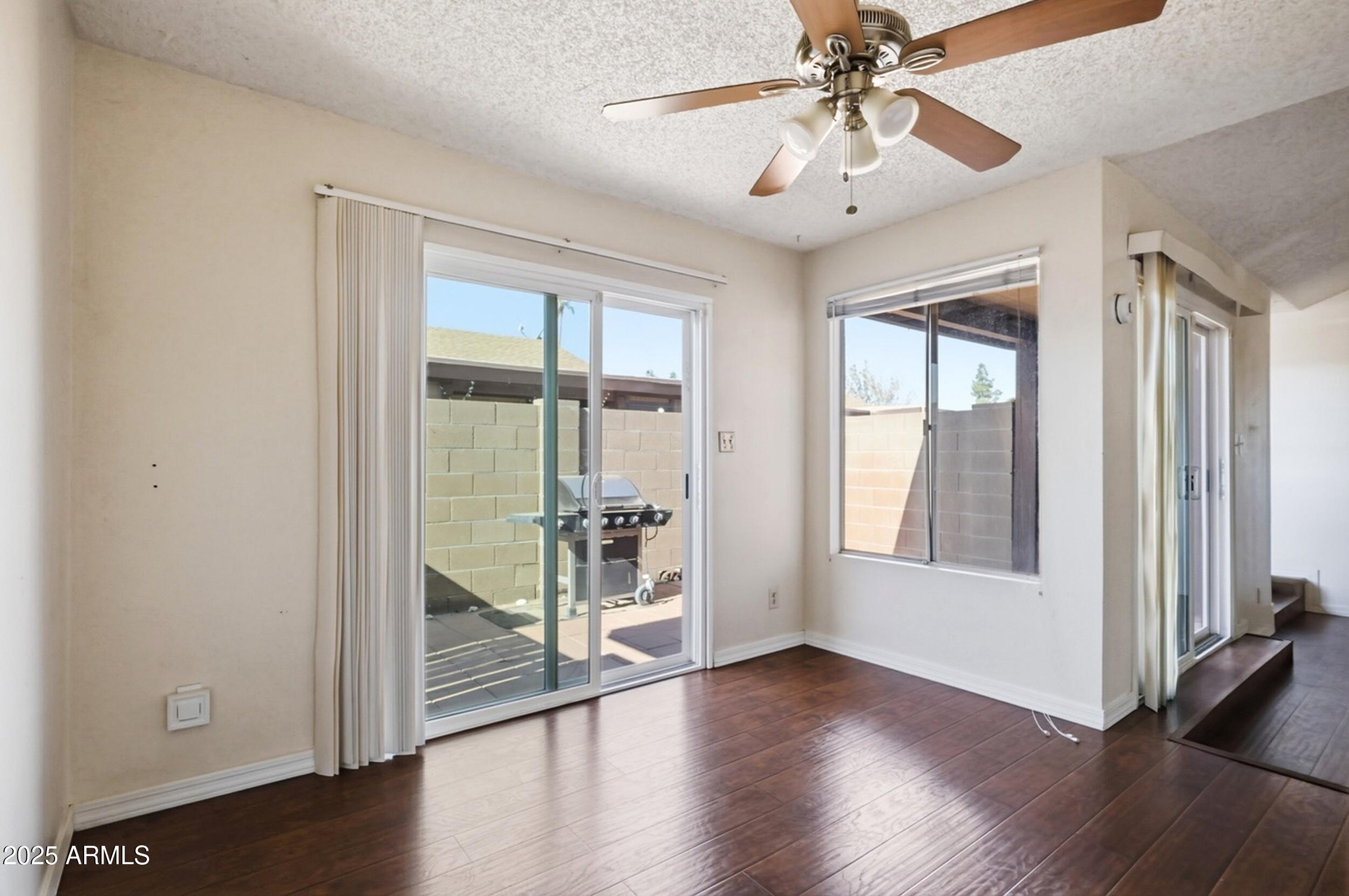 1831 East Kirkland Lane, Unit B Tempe, AZ 85288 - Photo 8 of 33 wooden floor in an empty room with a window