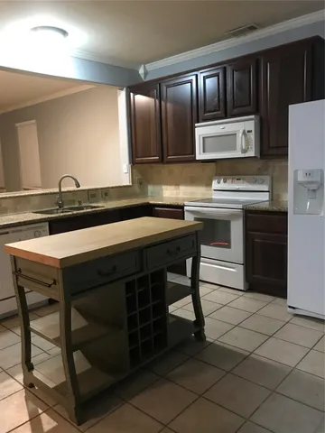 a kitchen with a sink appliances and cabinets