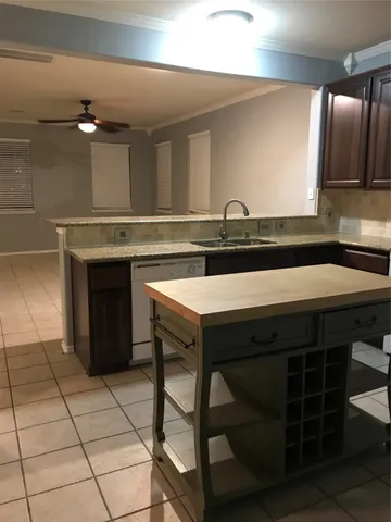 a kitchen with a sink cabinets and appliances