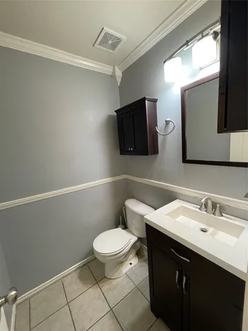 a bathroom with a sink a toilet a mirror and vanity