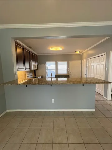 a kitchen with a sink cabinets and appliances