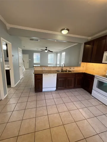 a kitchen with stainless steel appliances a stove a sink and a refrigerator