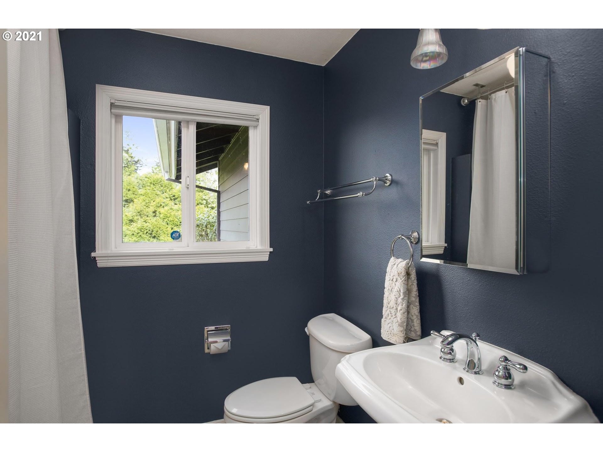 15620 Northwest Gillihan Road Portland, OR 97231 - Photo 13 of 29 a bathroom with a toilet sink and mirror