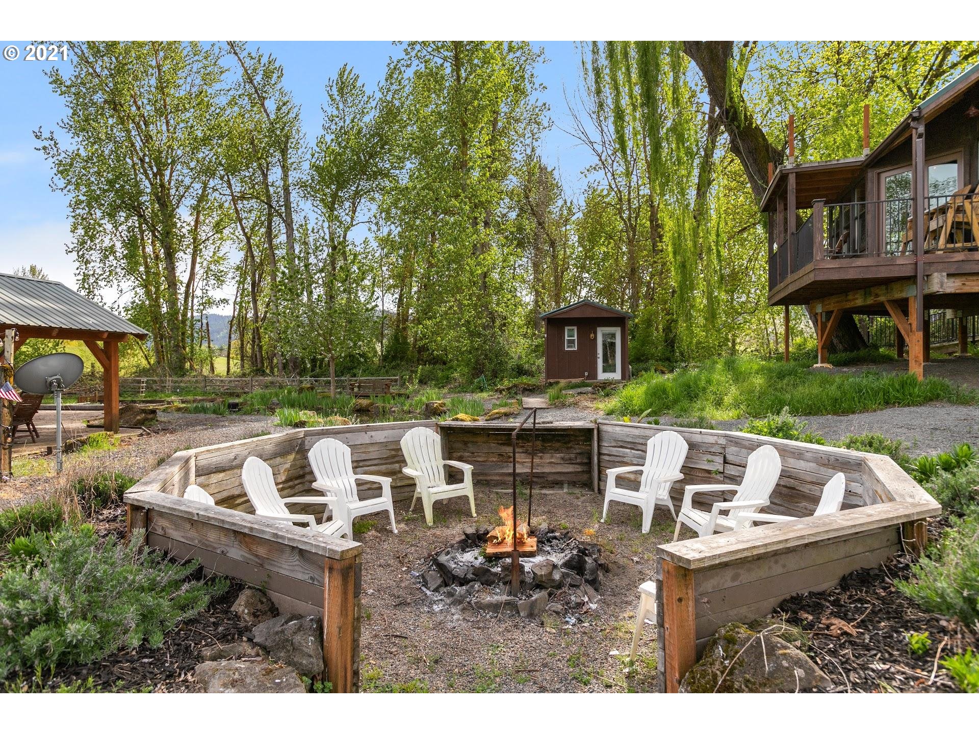 15620 Northwest Gillihan Road Portland, OR 97231 - Photo 21 of 29 a view of a patio with table and chairs potted plants and large tree