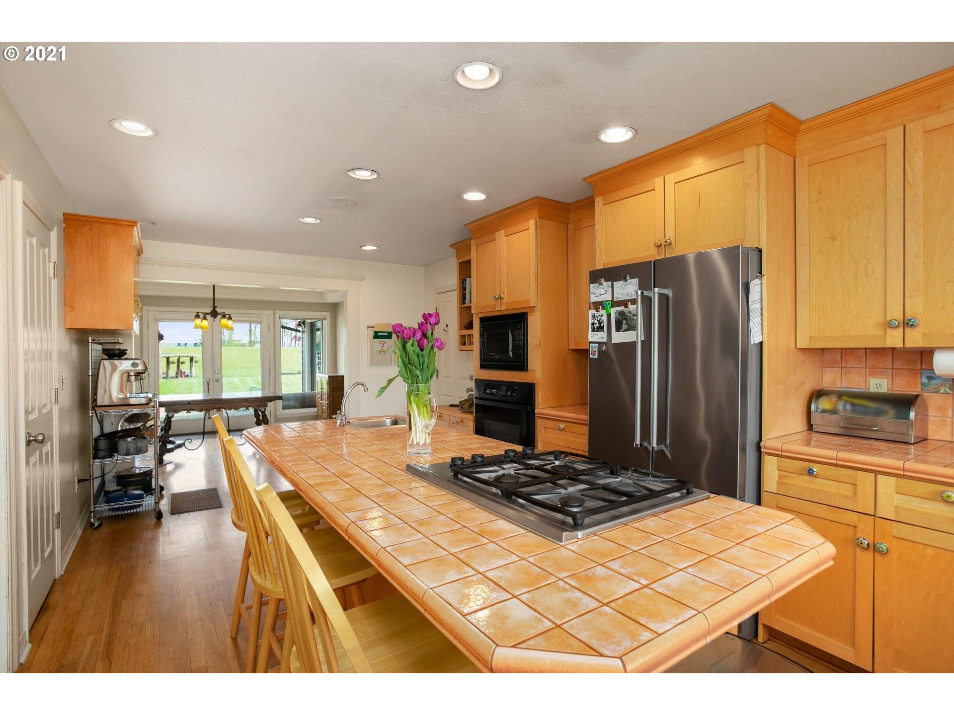 15620 Northwest Gillihan Road Portland, OR 97231 - Photo 8 of 29 a kitchen with stainless steel appliances granite countertop a refrigerator a stove and a sink