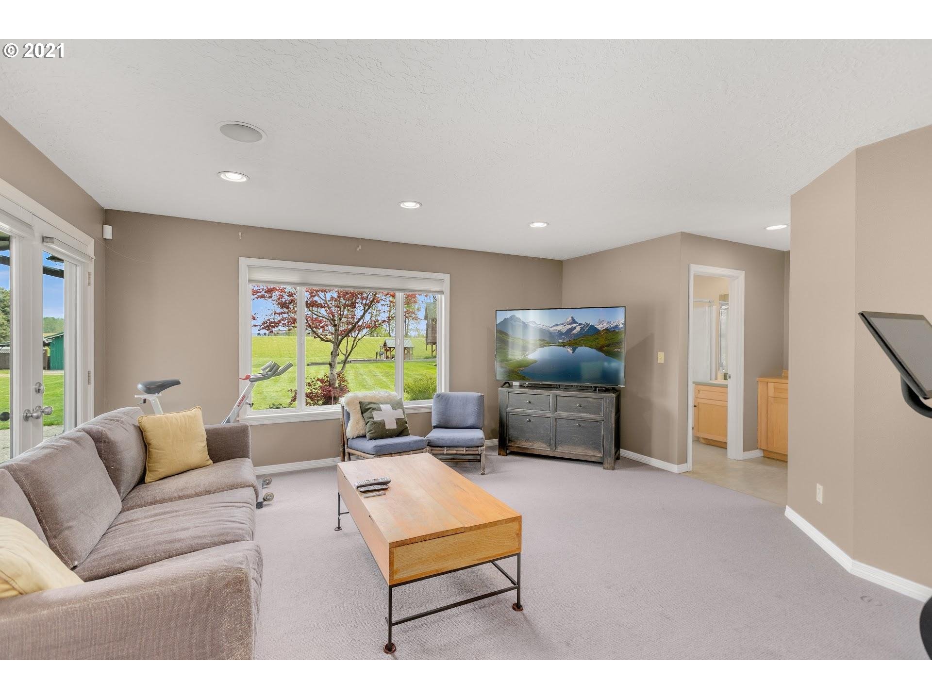 15620 Northwest Gillihan Road Portland, OR 97231 - Photo 9 of 29 a living room with furniture and a flat screen tv