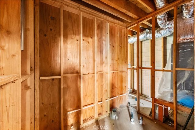 a view of an empty room with wooden floor and walls