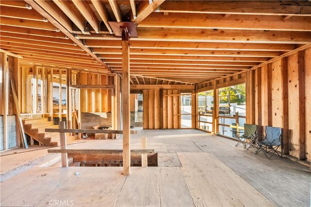 a spacious bedroom with a large bed and a chandelier