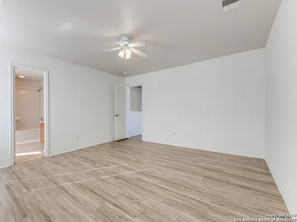 a view of an empty room and wooden floor