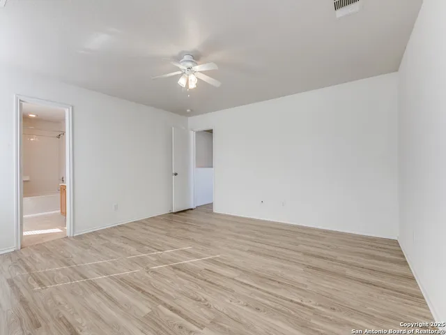 a view of an empty room and wooden floor