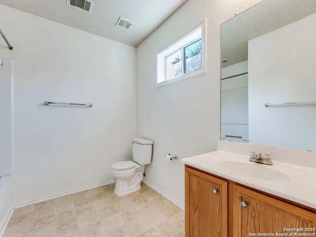 a bathroom with a sink a toilet and a mirror