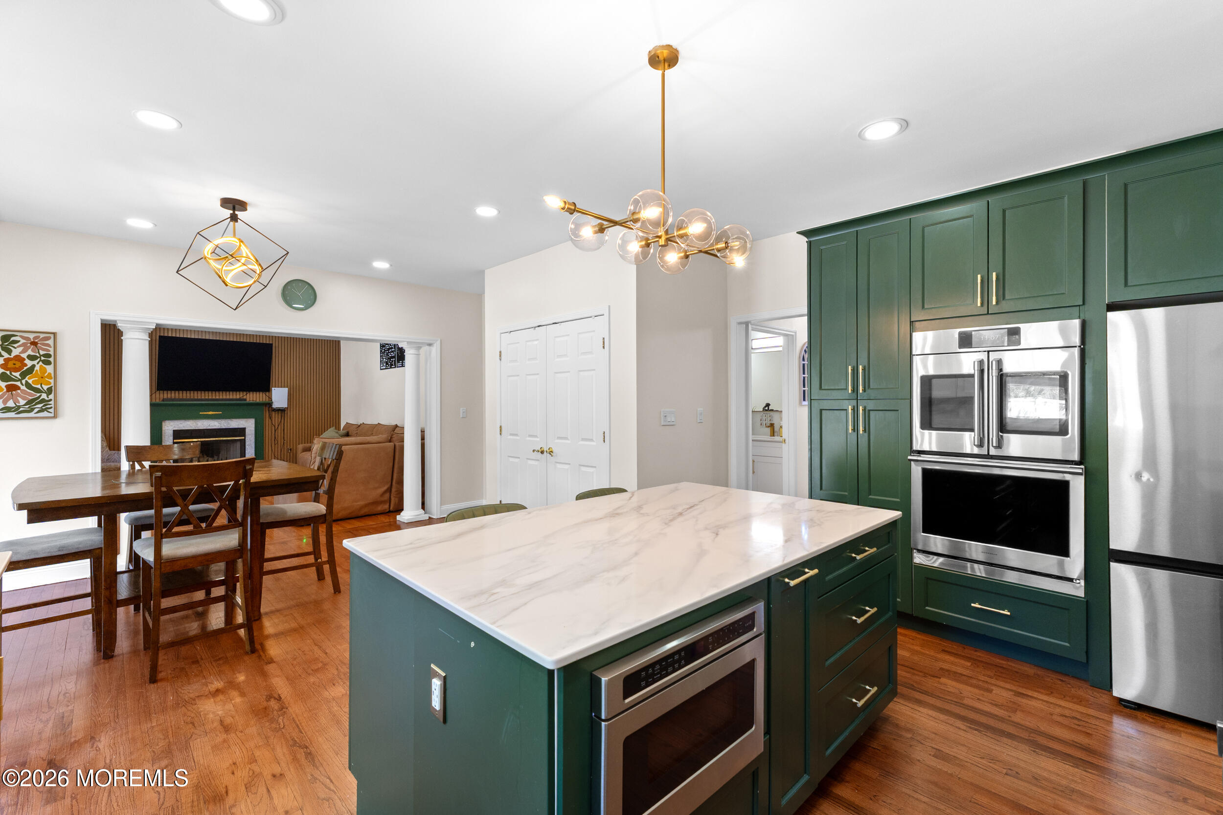 104 Autumn Road Matawan, NJ 07747 - Photo 15 of 64 a kitchen with kitchen island a sink stainless steel appliances and chairs