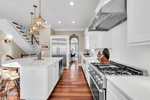 a kitchen with stainless steel appliances granite countertop a stove and a sink